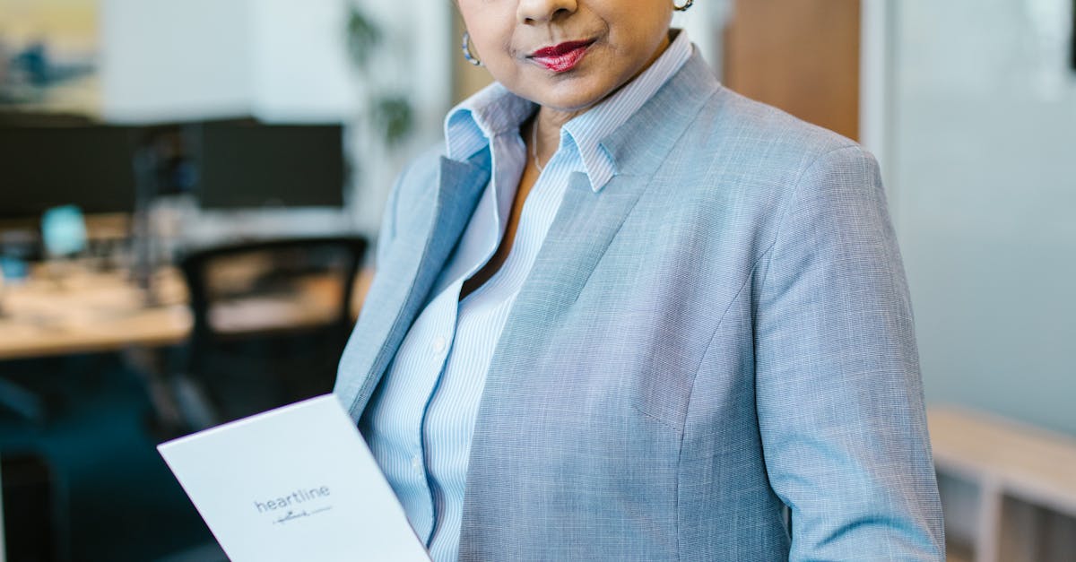 Confident businesswoman in office holding a document, showcasing professionalism and leadership.